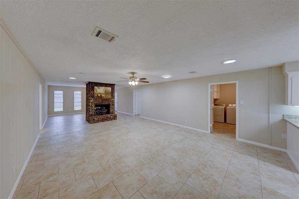 The front hall opens to a huge living room with fireplace.