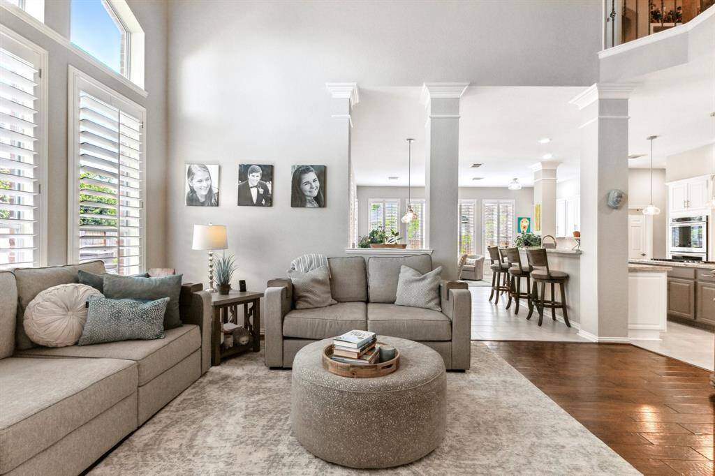 The open concept home gives you a glimpse of the newly updated kitchen and breakfast space. Again, columns with crown molding exquisitely delineates the three spaces.