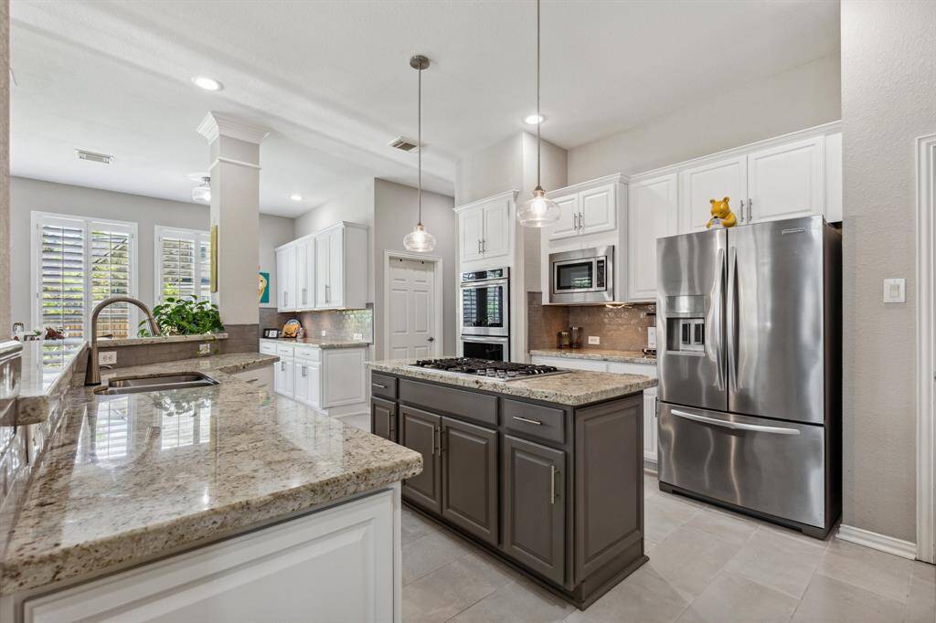 Updated tile blends beautifully with the designer colors of the kitchen.