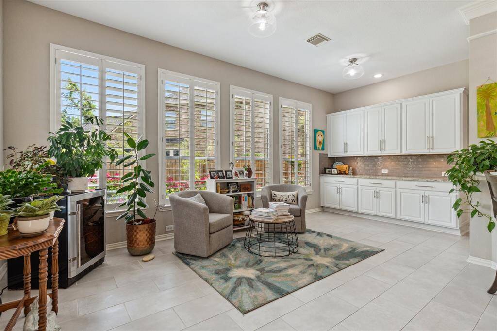Sunroom overlooks the sparkling pool and has built-in buffet with upper and lower cabinets for additional storage. There is no shortage of storage space in this home.