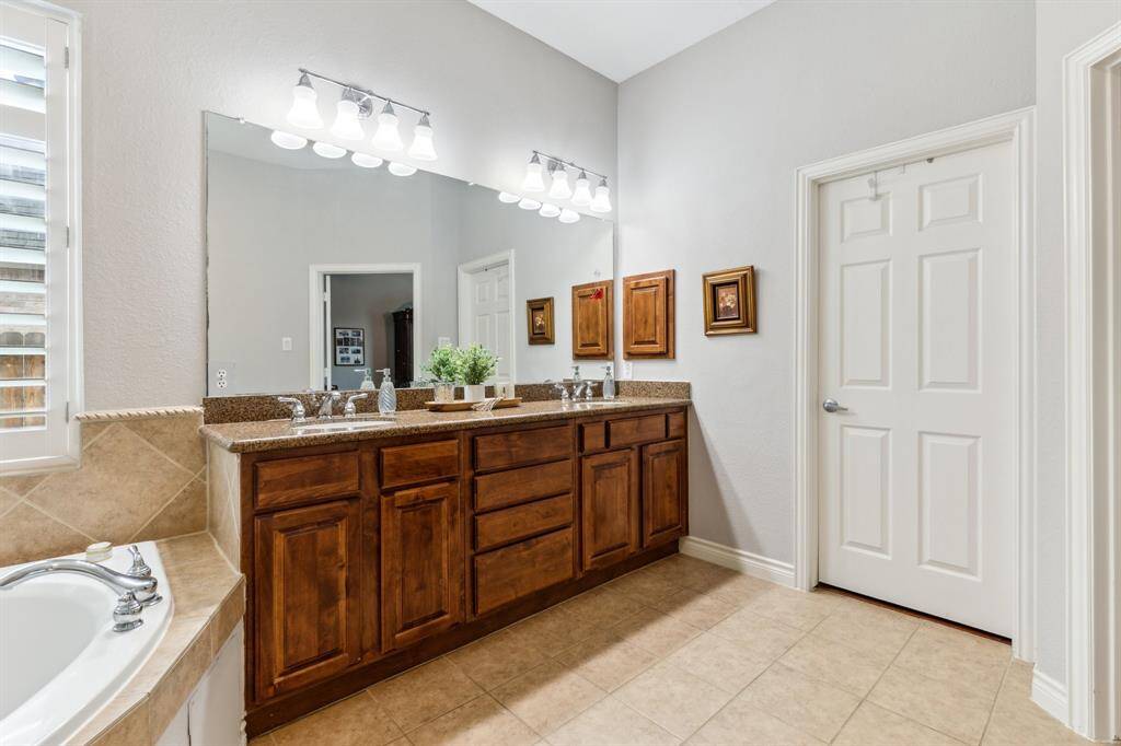 Another look at the vanity with four drawers and four cabinets. Just beyond the door is a large walk-in closet with a plethora of room for your wardrobe.