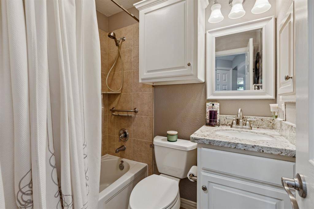 Full bath that services the downstairs guest room as well as a powder room for guests. White cabinetry, Granite counters and nice storage. Combination tub/shower for flexibility.