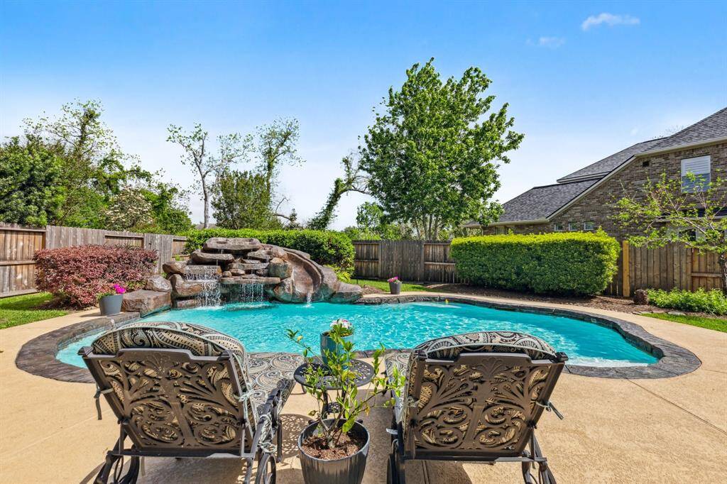 Enjoy the view of this sparkling pool with state-of-the-art in-floor cleaning system, updated pool equipment, resurfaced gunite, water features and a slide for playful afternoons.