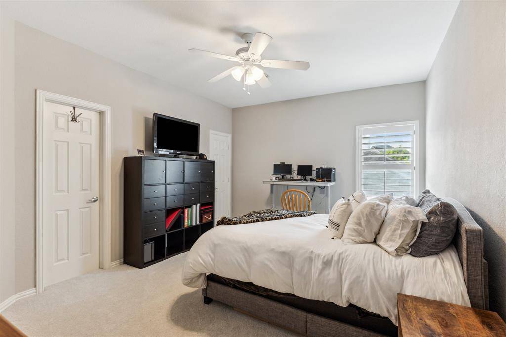 First guest room with ensuite bath and large walk-in closet. Ceiling fan and new carpeting make this a terrific space for either a guest or family member.
