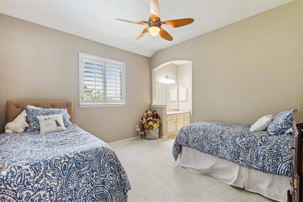 Bedroom 5 with new carpet, ceiling fan and separate vanity and adjoining jack & jill bath. Double windows with plantation shutters.