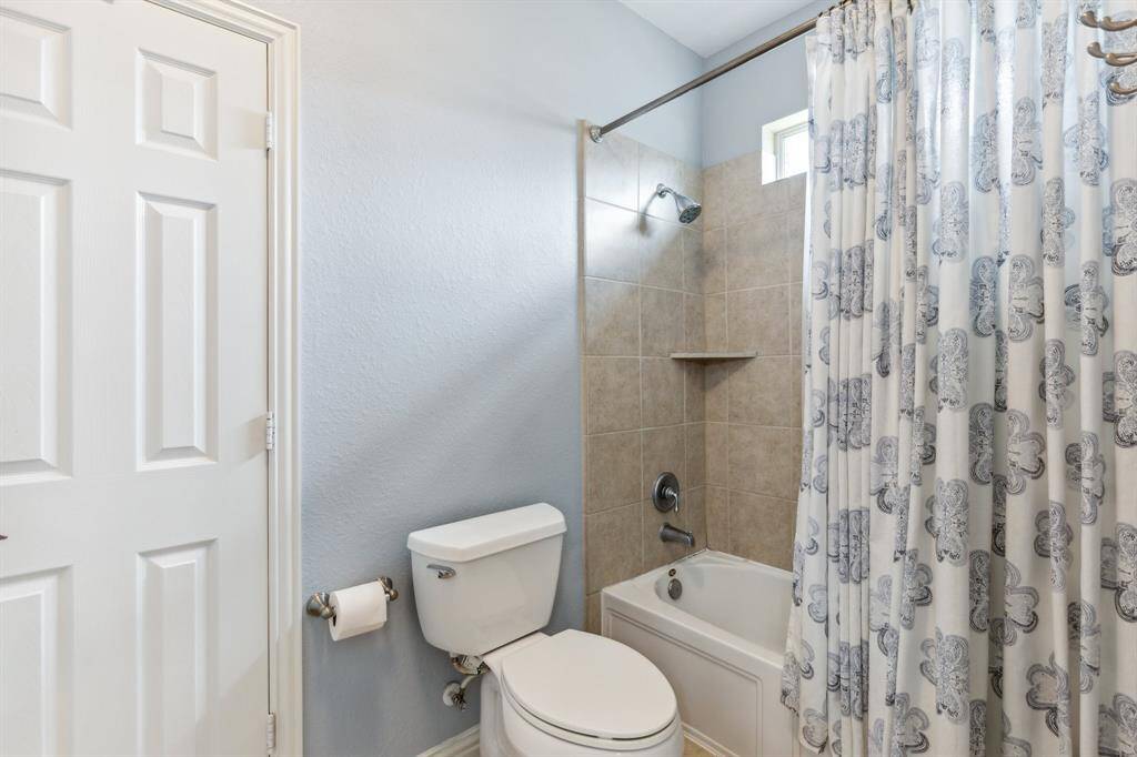 Combination tub/shower and commode portion of the jack & jill bath.