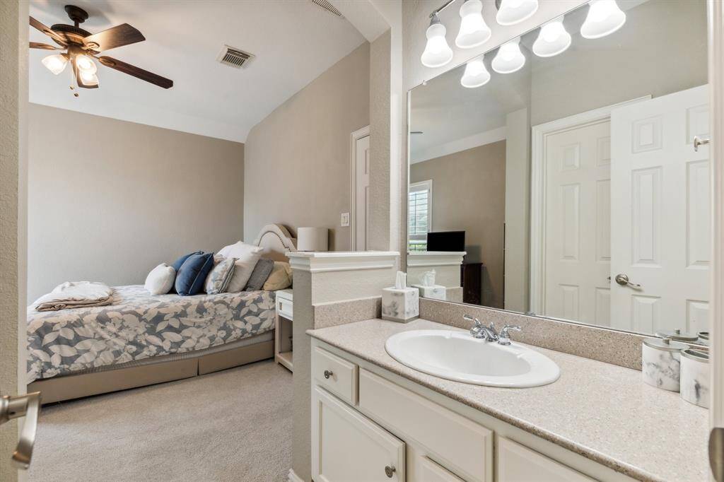 Bedroom #6 has new carpeting, ceiling fan, plantation-shuttered window in this spacious bedroom