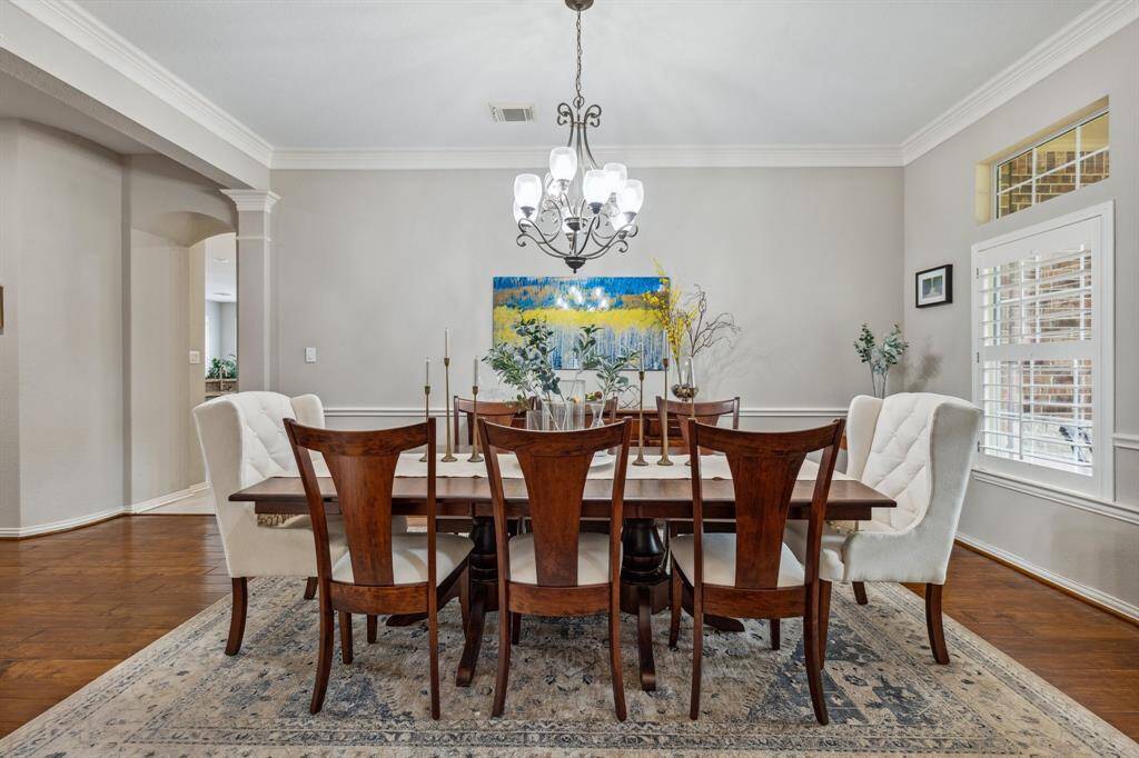 Fabulous dining space is large enough for a large round or rectangle with all the leaves. Plantation shutters (throughout the home) adorn the window while the transom allows light from the covered brick porch.
