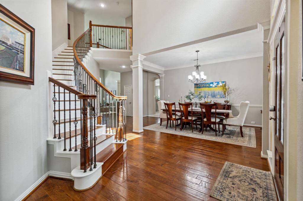 Classic wrought iron spindles and wood railings serve as a great location for a photo ops. Look at this gleaming hard wood floors.