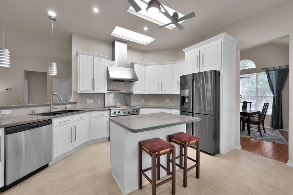 This kitchen dazzles! Sleek stainless appliances and freshly painted white cabinetry provide a perfect backdrop for the home chef!