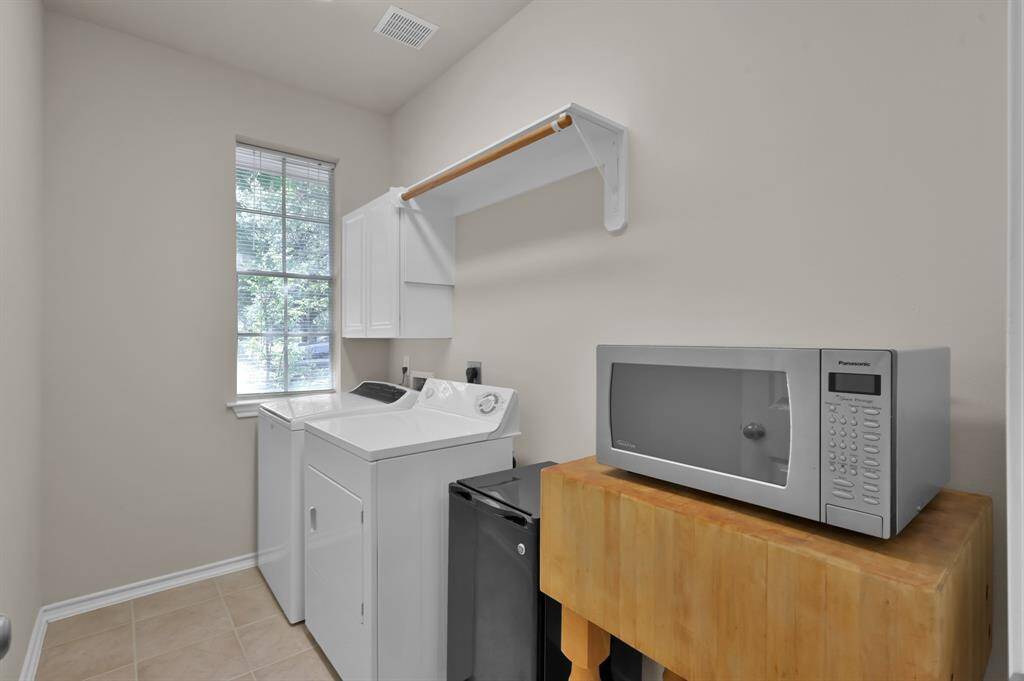 Oversized utility room with plenty of space for a folding table or second refrigerator.