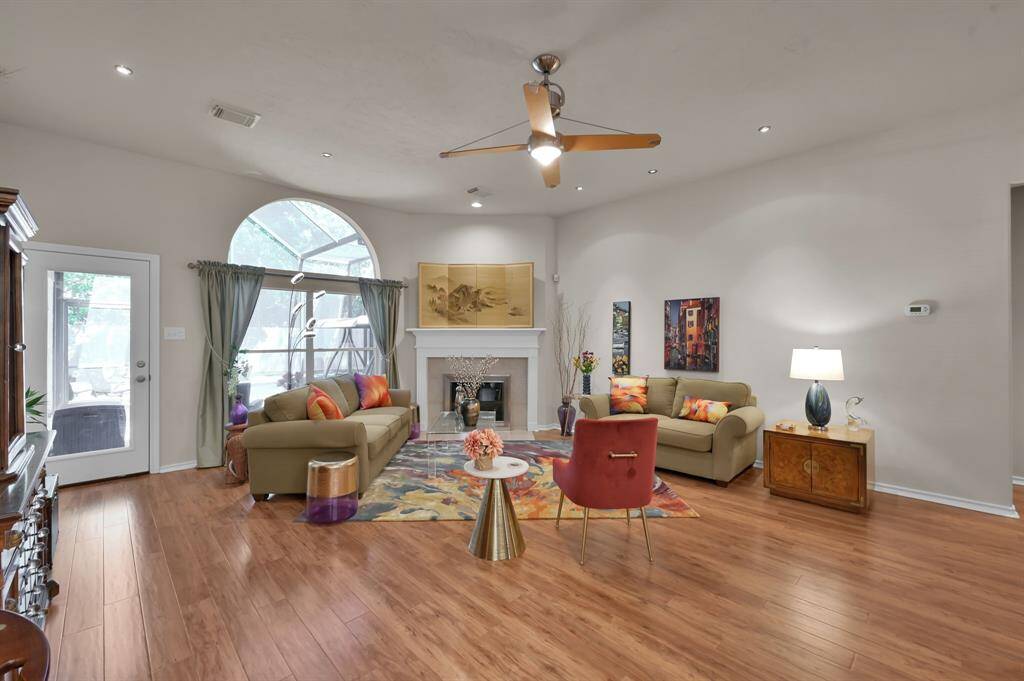 Custom lighting and fixtures add extra charm to this spacious living room.