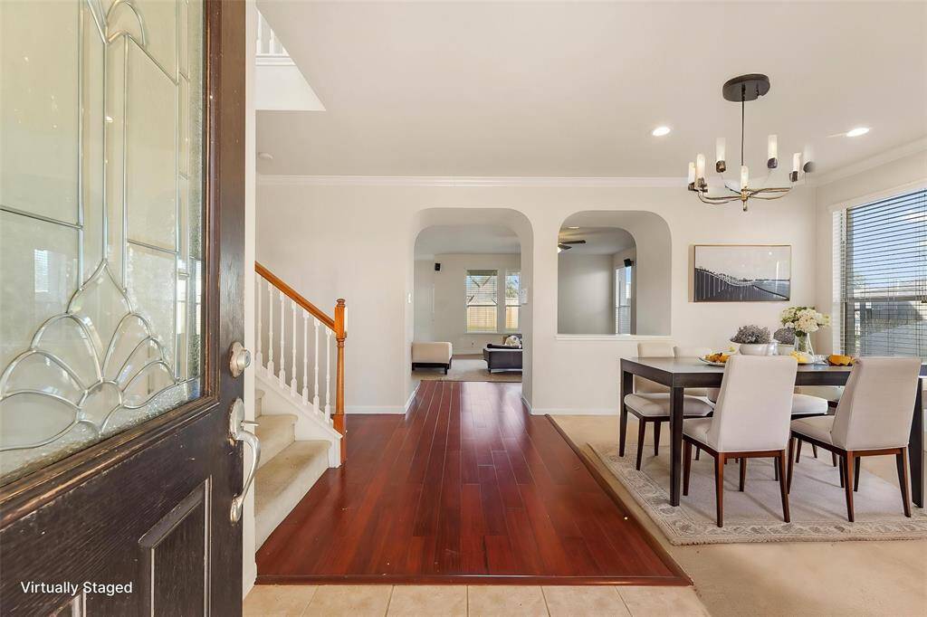 Formal entry into the home, leading into a spacious flex room. Great for dining, sunroom, or even additional living room, etc. (Virtually Staged)
