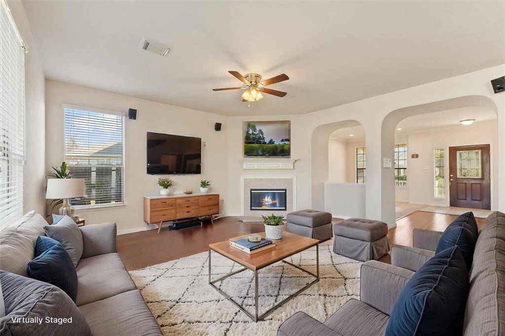 Spacious living room that is pre-wired for surround sound and home theater (Virtually Staged - Fireplace activity is simulated)