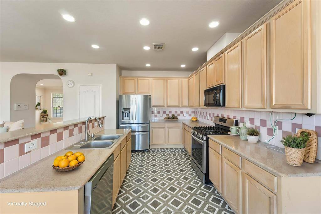 Well-cared for kitchen that opens up to the living room and dining area (Virtually Staged)