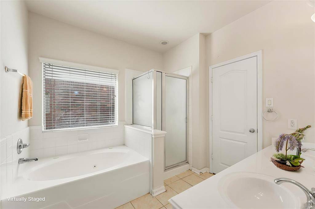 Double vanity with separate standing shower and soaking tub (Virtually Staged)