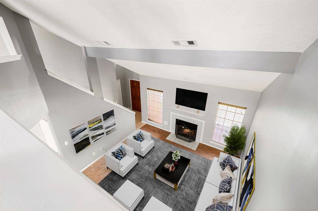 Overlooking the living room from upstairs this home boasts of high ceilings and plenty of space to accomodate all your needs! *Virtually Staged