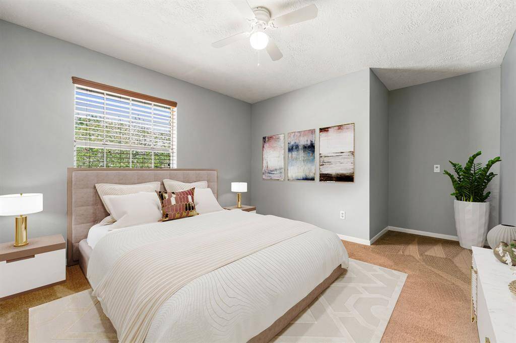 Secondary bedroom features a large window with plenty of natural light, a ceiling fan with light, plush carpet, and neutral paint. Turn this room into a guest room, office, gym or anything else that suits your needs. *Virtually Staged