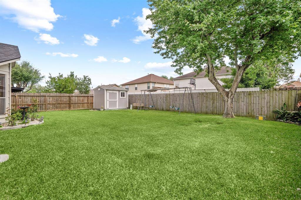 Fully fenced backyard with enough space to plant a garden, add a pool, or a playground.
