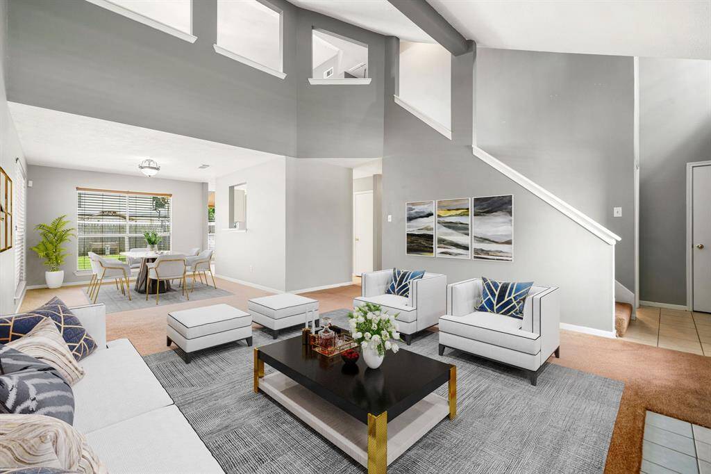 Gather the family and guests together in your lovely living room! Featuring soaring high ceilings, and custom paint and large windows that provide plenty of natural lighting throughout the day. *Virtually Staged