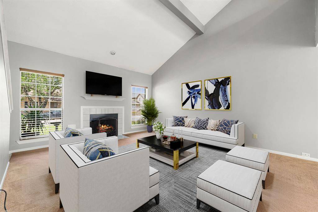 This light and bright spacious living room is the perfect layout for entertaining or just relaxing. Whether it's simply a night in or entertaining family and friends, this home has ample open space for everyone to enjoy! Featuring dark stained ceiling fan, large tile flooring, large windows with blinds, soaring high ceilings, recessed lighting with wonderful access to your gorgeous kitchen. *Virtually Staged