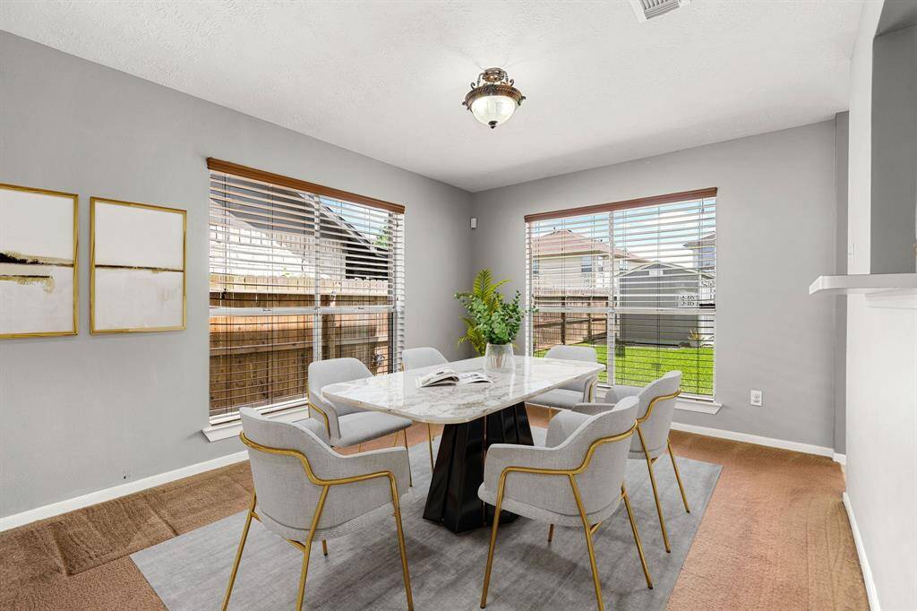 You and your guests will certainly dine in style in this amazing formal dining room! Featuring a gorgeous modern chandelier, large window with blinds, neutral paint, and high ceilings. Perfect space to entertain family and friends. *Virtually Staged