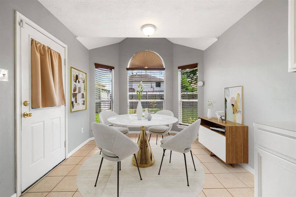 Make memories gathered around the table with your family and friends! This dining room features high ceilings, large windows, and tile floors. *Virtually Staged