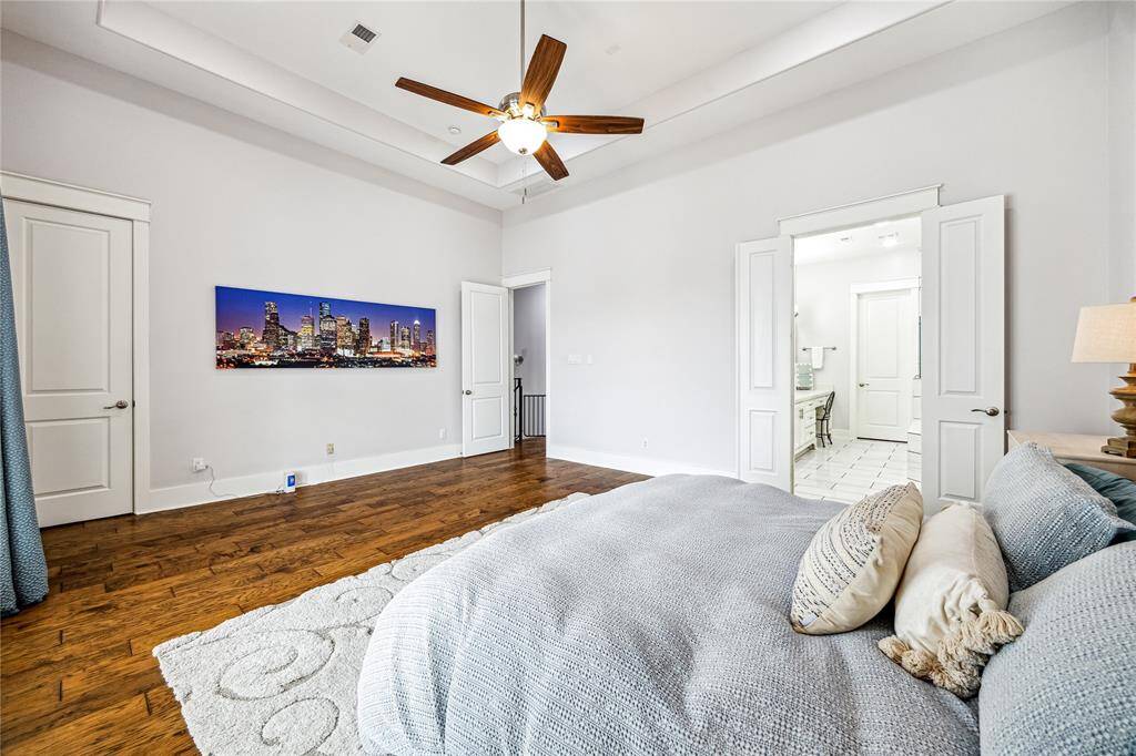 Located on the third level, the spacious primary bedroom features easy-care wood floors and opens to a private, expansive balcony. The luxurious ensuite bath offers a spa-like experience.