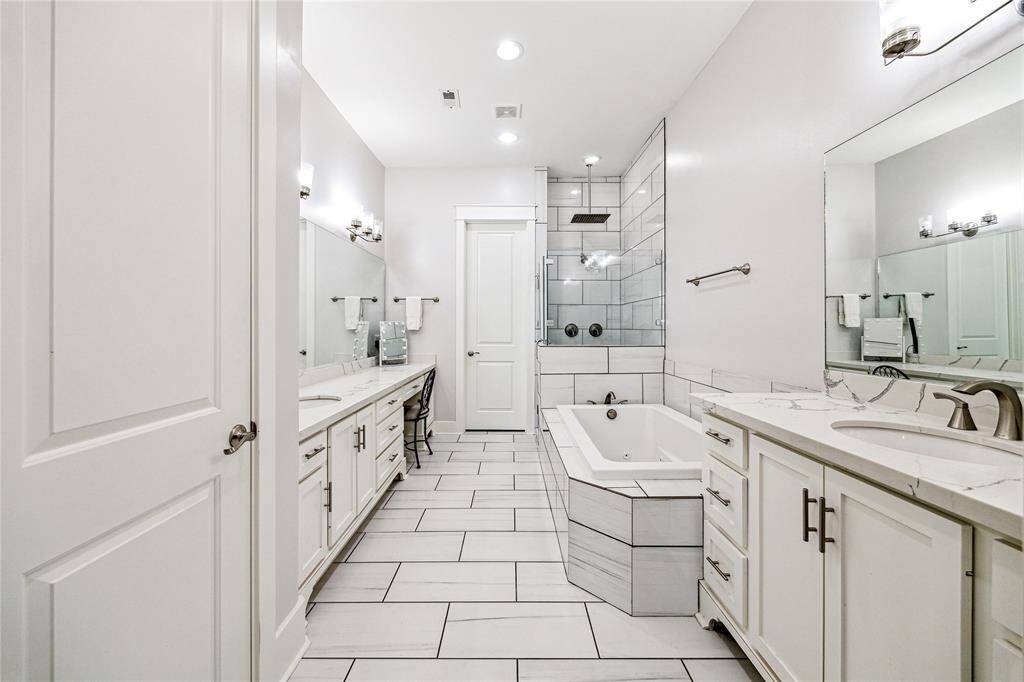 The ensuite bath in the primary suite is a true sanctuary, featuring dual vanities for added convenience and a spacious soaking jetted tub for ultimate relaxation. A separate, elegant shower offers a refreshing retreat, while the dedicated vanity area adds a touch of sophistication and functionality.