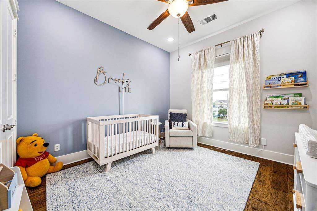This generous secondary bedroom on the third level offers plenty of space and natural light, making it perfect for family, guests, or even as a home office. Equipped with blackout shades for ultimate comfort and privacy.