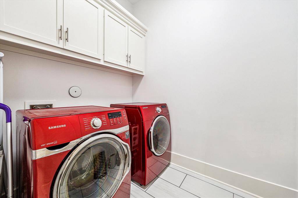 Large utility room, thoughtfully designed to handle all your laundry and storage needs.