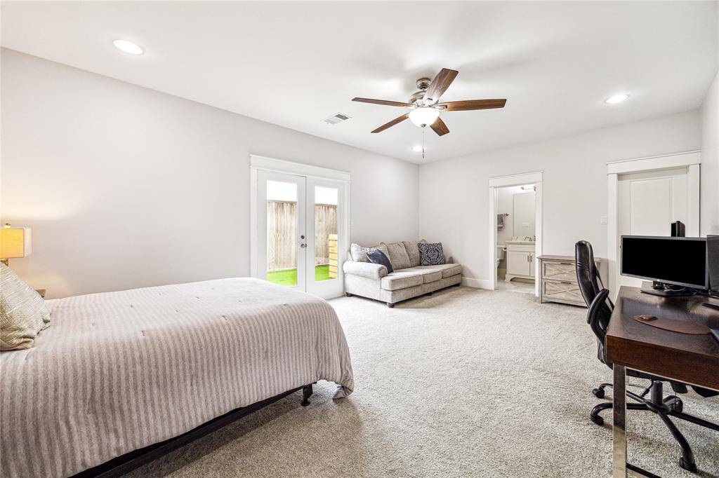Oversized ensuite bedroom offers versatility and direct access to the fenced backyard—perfect as a guest suite, home office, or private retreat.