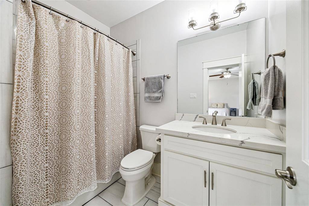 Private ensuite bathroom on the first floor, offering a sleek and functional space.