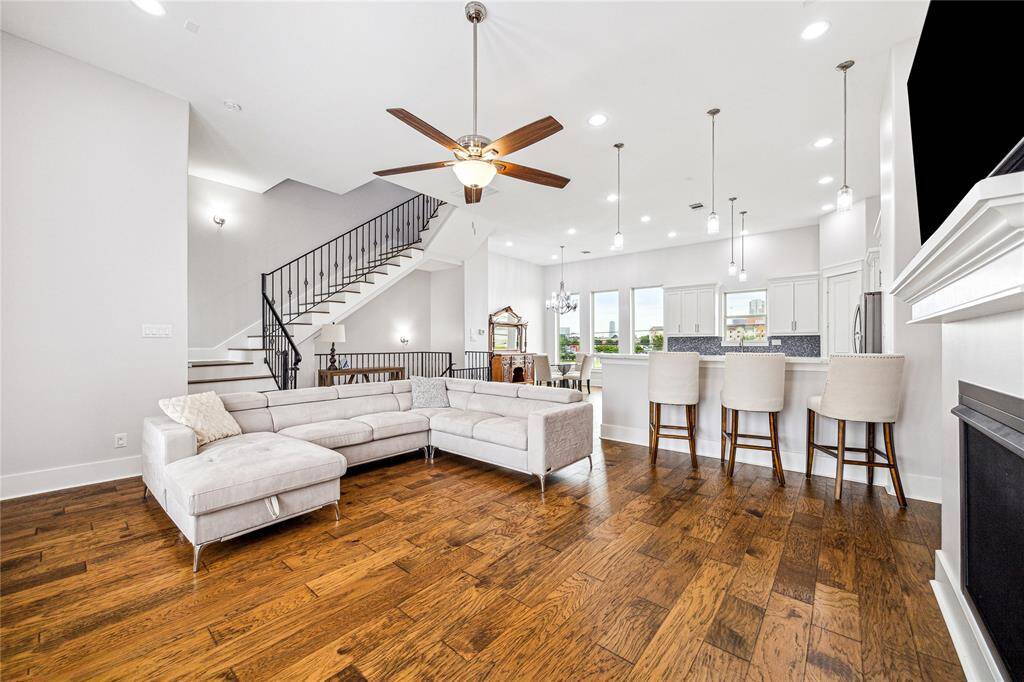 Thoughtfully designed with soaring ceilings, elegant finishes, and abundant natural light, the space features a cozy fireplace.
