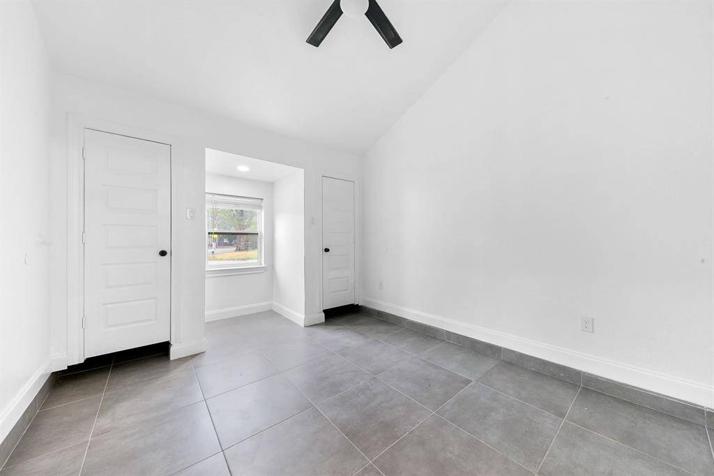Stylish tile floors in the primary bedroom offer durability and easy maintenance for a cozy retreat!