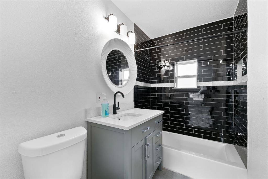 Updated bathroom with a sleek tile shower—perfect for everyday comfort and convenience