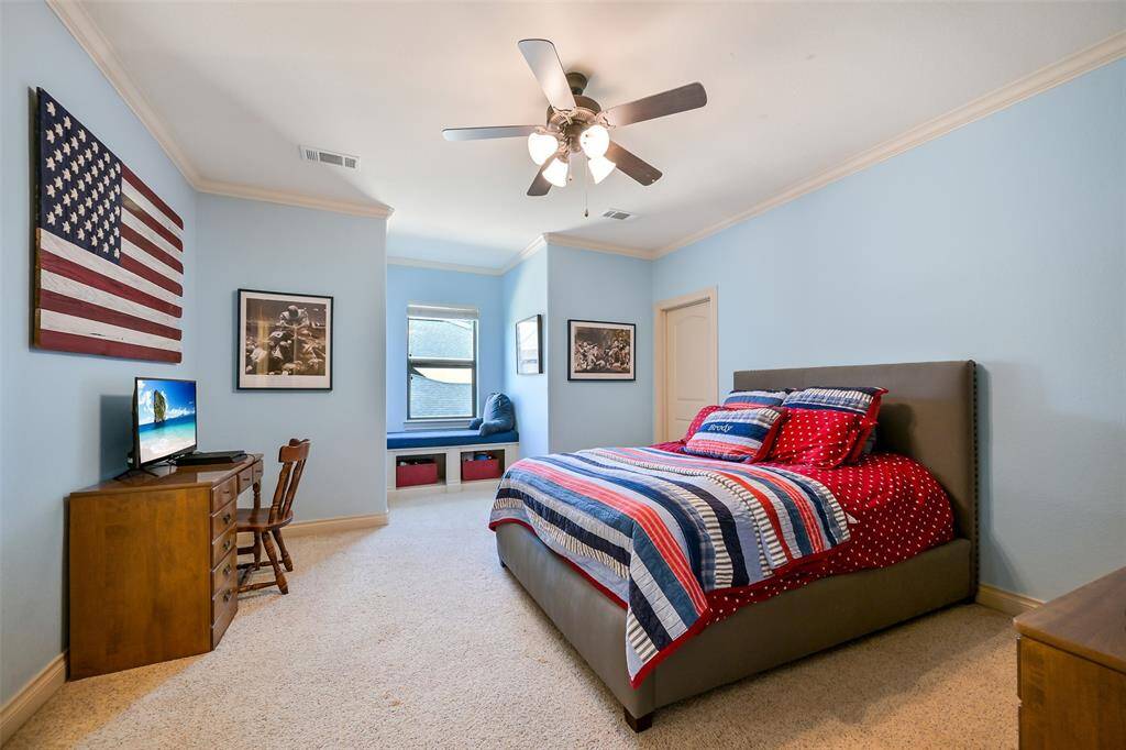 This bedroom features natural light from a window with a built-in bench, creating a welcoming atmosphere. Attached to this bedroom is a full sized bathroom and walk in closet.