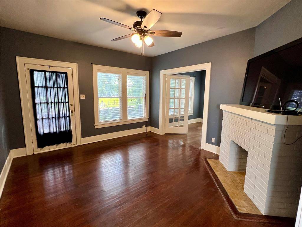 Living room has plenty of natural light and the front door leads out to the deck.