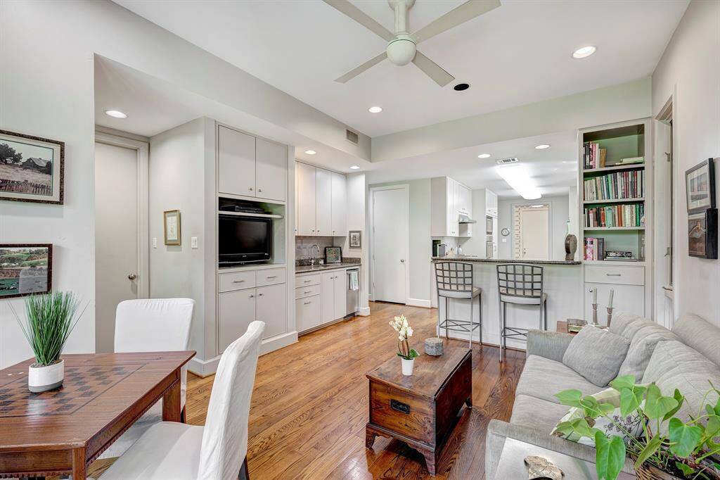 The cozy sitting area adjacent to the kitchen has a wet bar, tv cabinet and access to the primary suite.