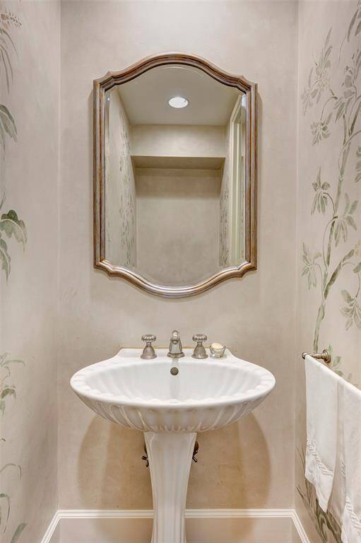 The downstair guest powder room is tucked away under the stairs