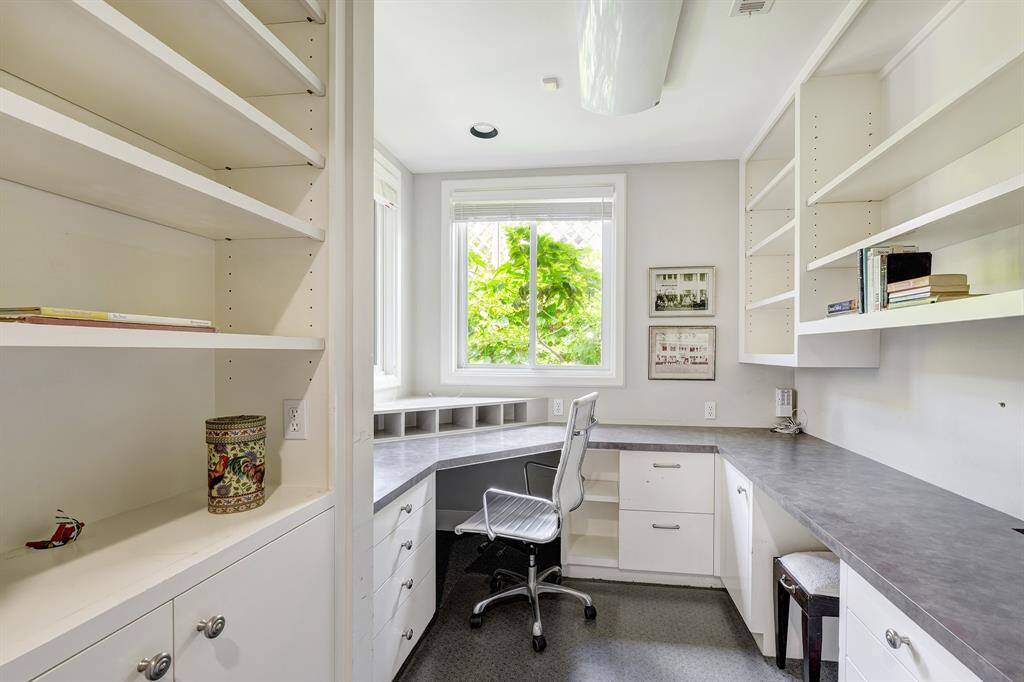 The efficient home office is light and bright and boasts wonderful space and storage.  It can be closed off with a pocket door.
