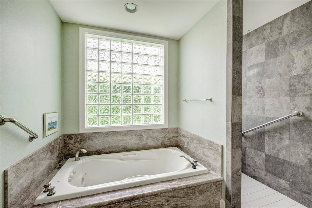 The large tub with the walk in shower to the right.