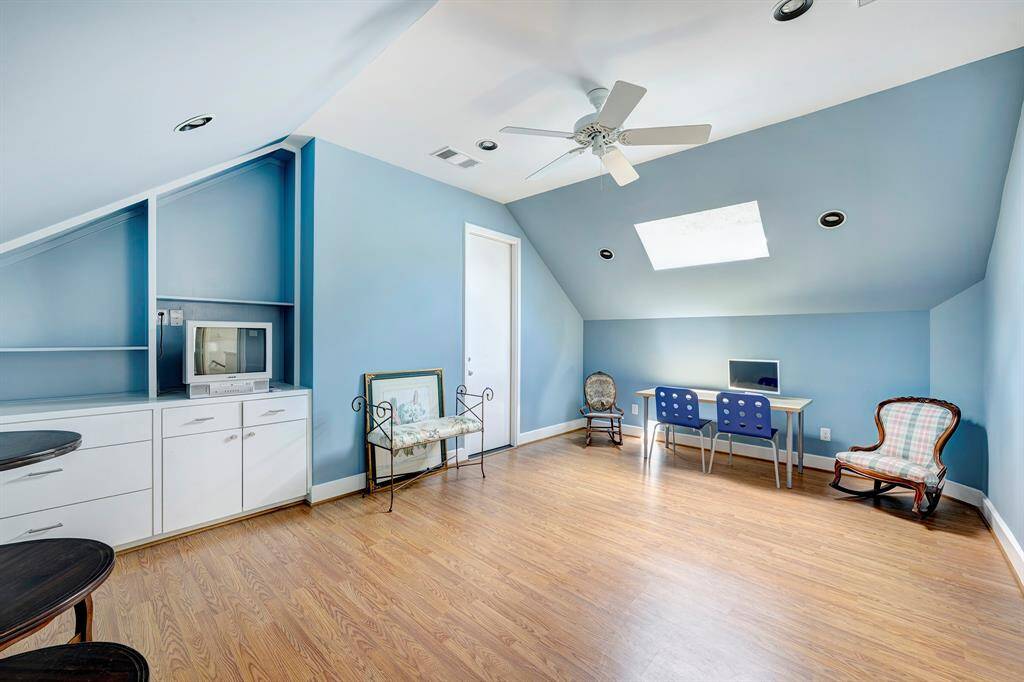 This is additional space for any number of uses:  exercise equipment, project room, tv and games.  The door leads to an incredible amount of walk in attic storage.