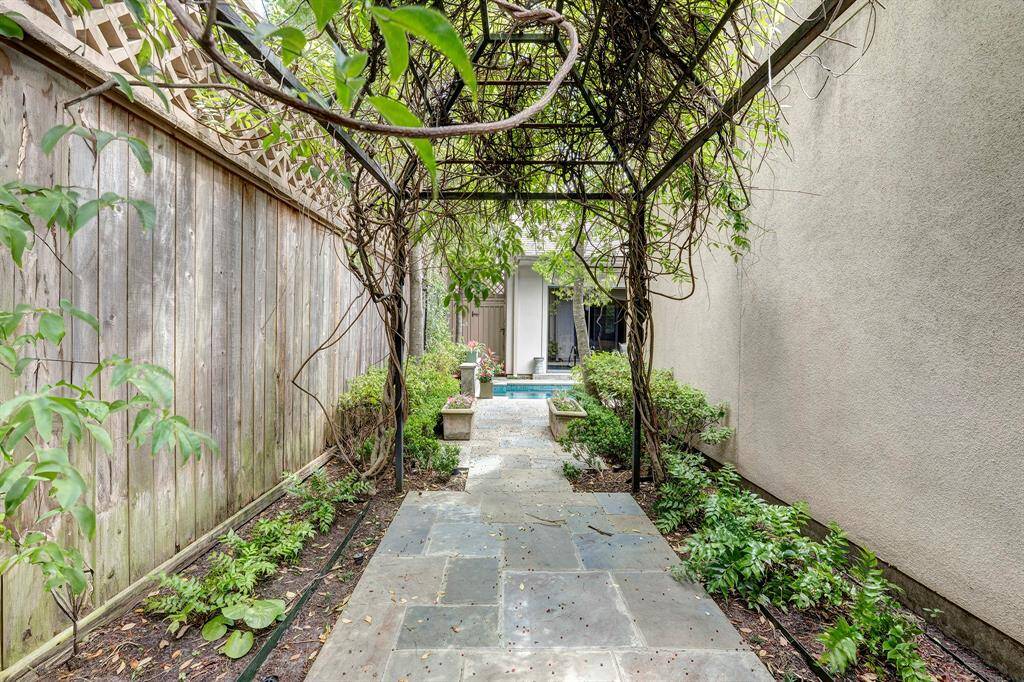 A lovely arbor and walk way lead to the other side of the house.