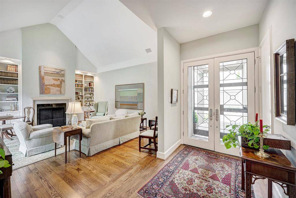The decorative iron gates to the entry provide style and security and bring light into the entry area, highlighting the gleaming hardwood floors throughout the living areas.
