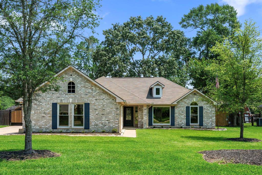 This charming single-story home features a light brick exterior with dark shutters, a well-maintained lawn, and mature trees. Its inviting entrance and large tinted windows offer plenty of natural light, making it an ideal choice for a cozy, welcoming residence.