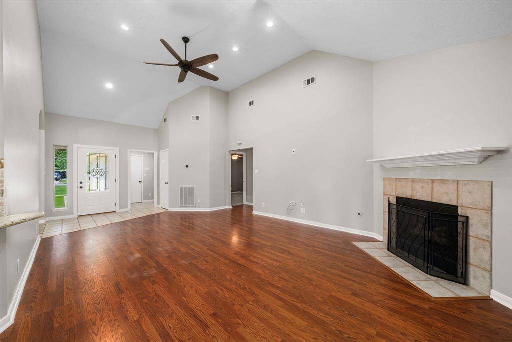 livingroom with valted ceiling and fireplace