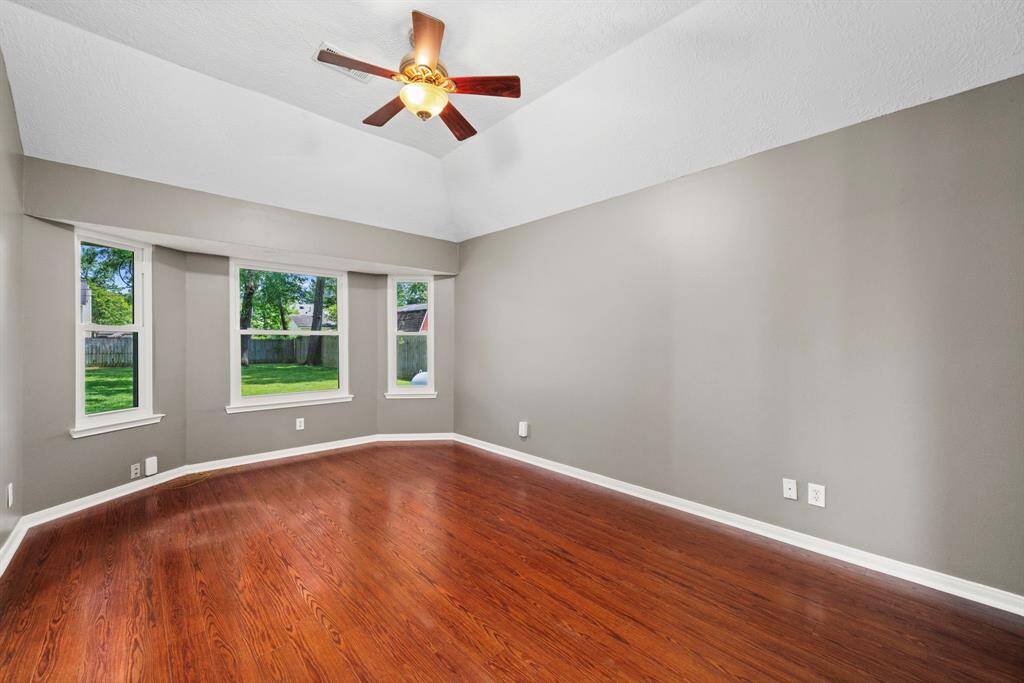 Spacious primary bedroom featuring a beautiful bay window and a cozy additional sitting area—perfect for relaxing or reading