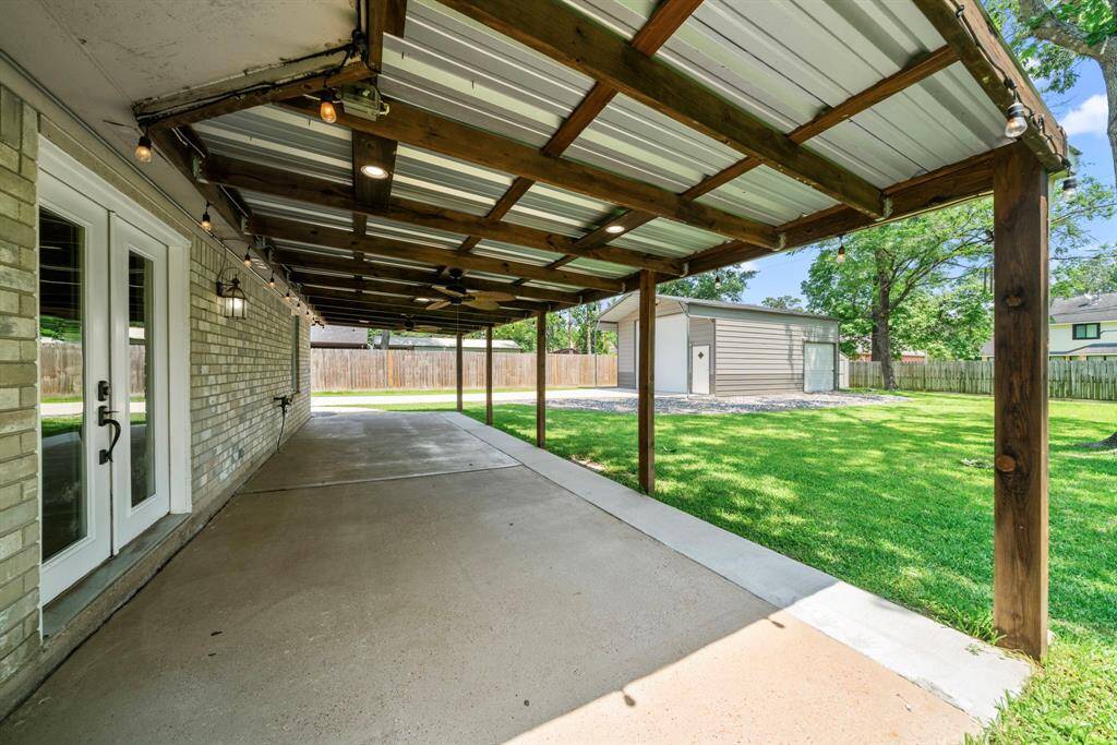 enjoy the large covered back patio complete with two ceiling fans and decorative string lights—ideal for outdoor gatherings or relaxing evenings