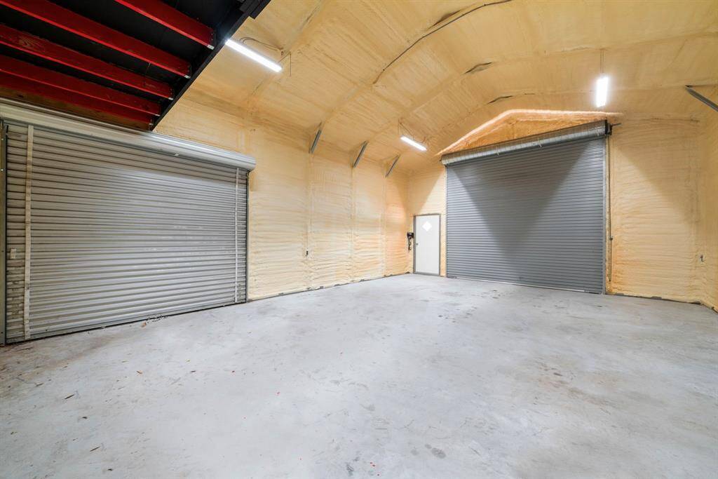Spacious shop with two roll-up doors, walk-through entry, electricity, and A/C—perfect for projects, storage, or a hobby space.